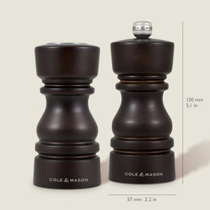 The Cole & Mason London Chocolate Wood Salt Shaker & Pepper Mill Set features two dark wooden mills, each 130 mm tall and 57 mm wide, with a premium grinding mechanism for enhanced performance.