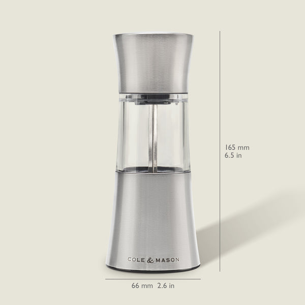 The Cole & Mason Stadhampton Chilli & Spice Mill, made of stainless steel and clear acrylic, stands upright with an ergonomic design, measuring 165 mm high and 66 mm wide. It is shown against a light background.
