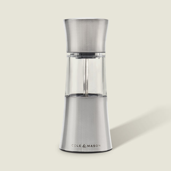 The Cole & Mason Stadhampton Chilli & Spice Mill features stainless steel and clear acrylic with an ergonomic design, COLE & MASON branding at the base, shown upright against a plain light background.