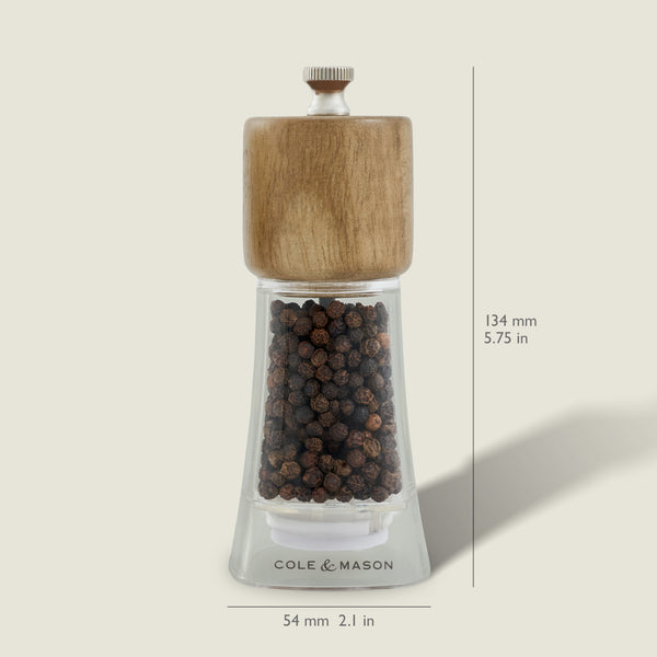 The Cole & Mason Woodbury Salt & Pepper Mill Set features clear mills with wooden tops, adjustable coarseness, and bold branding on the base. Each mill stands 134 mm tall and 54 mm wide, adding rustic charm to your table.