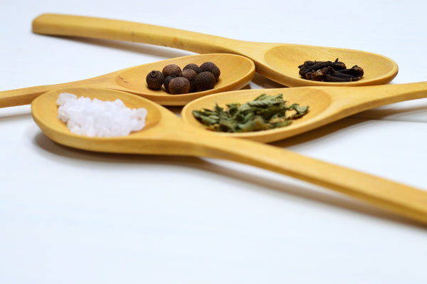 wooden spoons with salt and spices