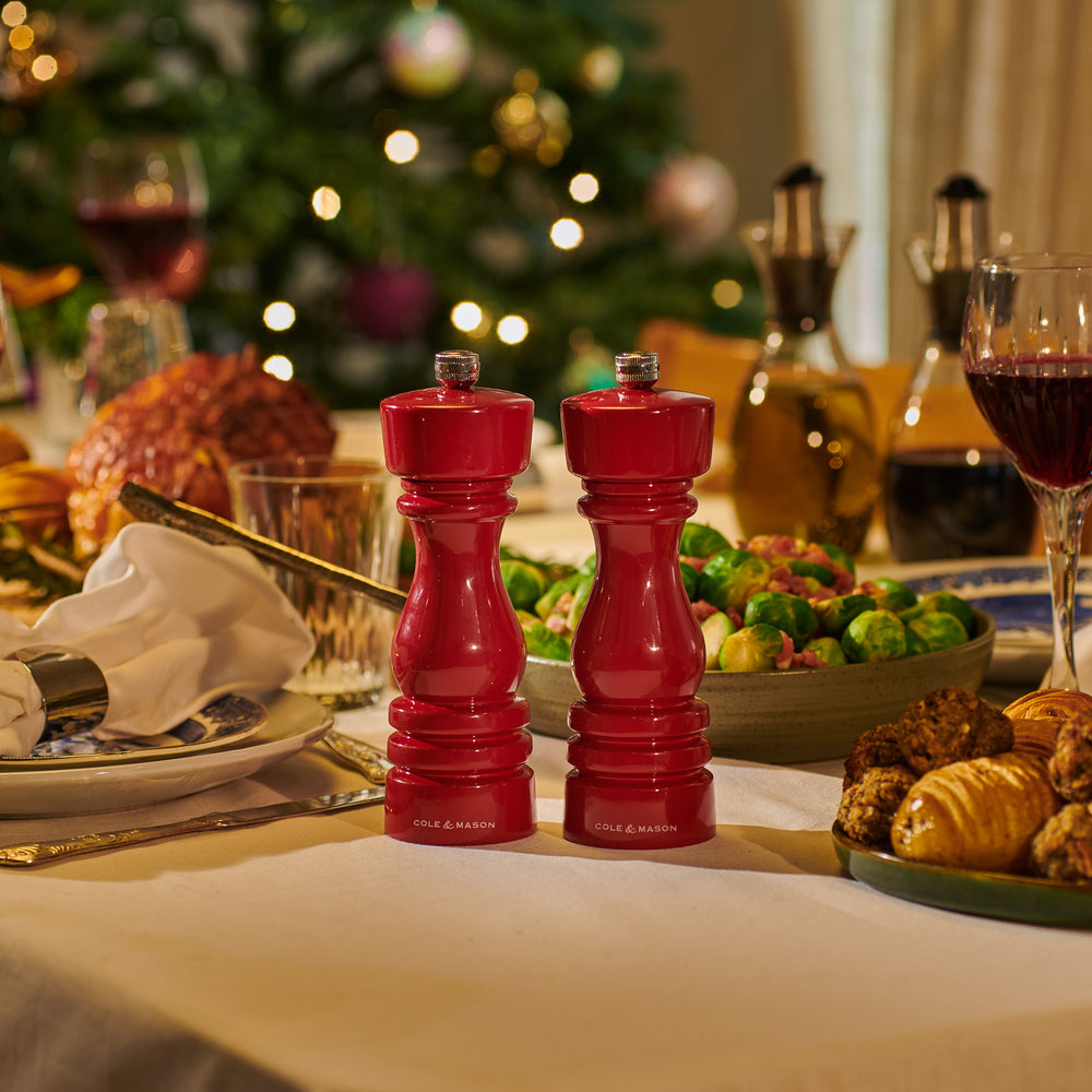 The London Red Gloss Mill Christmas Gift Hamper by Cole & Mason features a stylish salt & pepper mill set, two textured rolls, and a metal funnel in a black gift box with shredded paper—ideal for elegant Christmas gifting.
