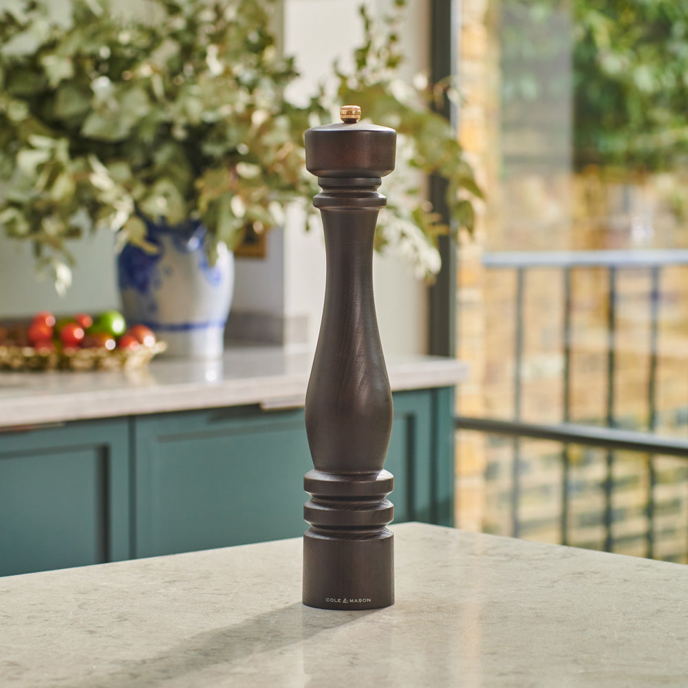 The Cole & Mason London Chocolate Wood Pepper Mill 400mm and silver refill funnel are elegantly displayed against a light background, both branded and beautifully presented in a luxury gift box.