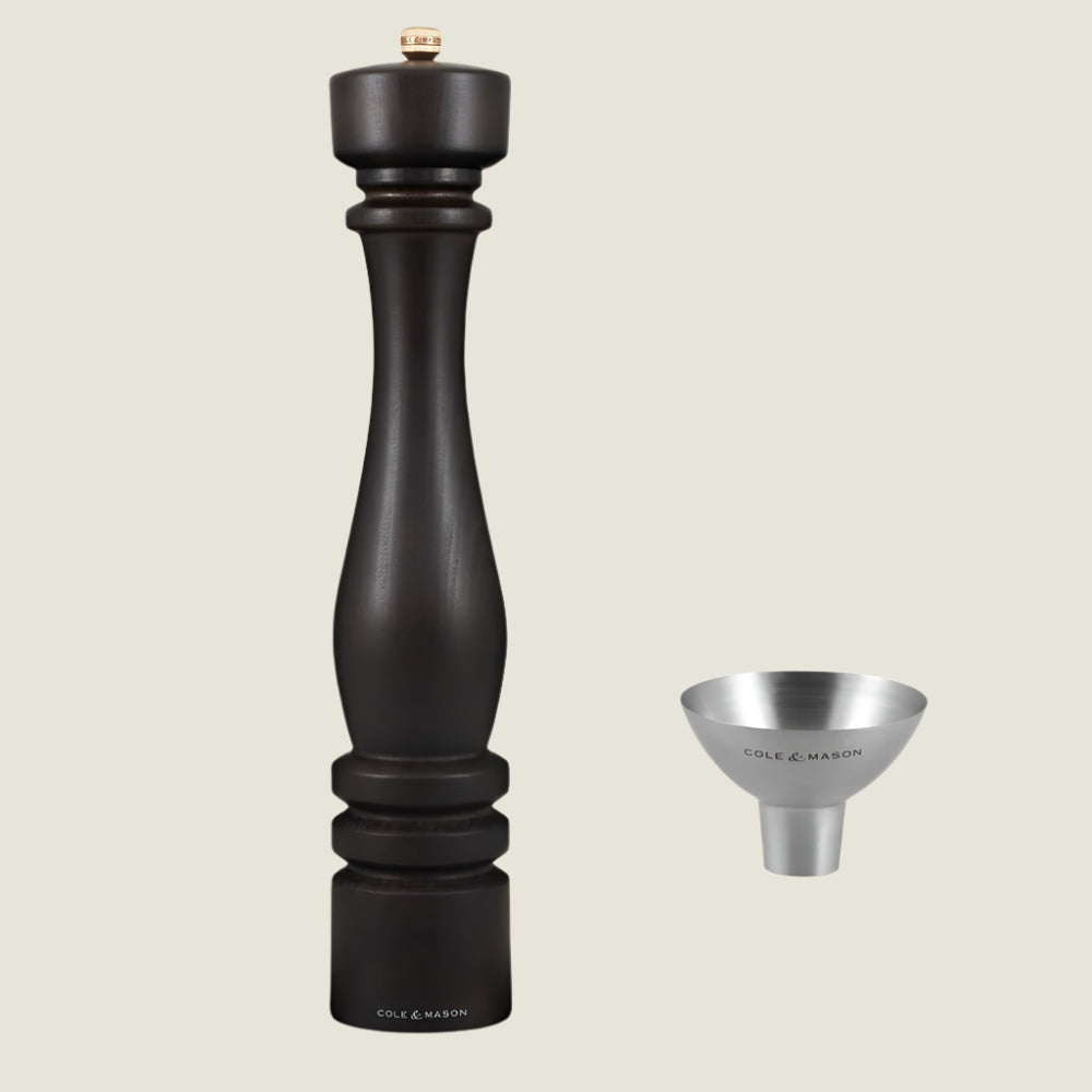 The Cole & Mason London Chocolate Wood Pepper Mill 400mm and silver refill funnel are elegantly displayed against a light background, both branded and beautifully presented in a luxury gift box.