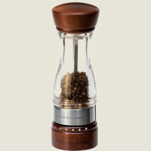 #pepper
The Cole & Mason Keswick Pepper Mill 180mm features clear glass, a walnut-stained wood body, a metal band, and is filled with black peppercorns—offering a stylish contemporary choice for gourmet seasoning.