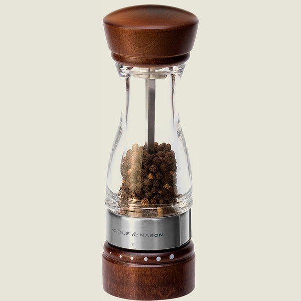 #pepper
The Cole & Mason Keswick Pepper Mill 180mm features clear glass, a walnut-stained wood body, a metal band, and is filled with black peppercorns—offering a stylish contemporary choice for gourmet seasoning.