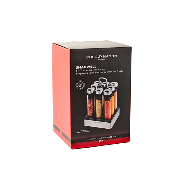 A boxed Cole & Mason Shadwell Countertop Spice Storage set is shown, featuring the spice rack with airtight containers, branding, and product details on a white background.
