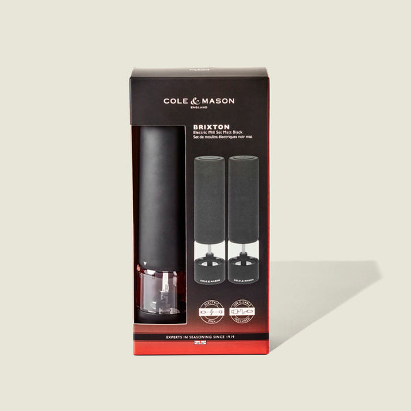 Cole & Mason Brixton Electric Mill Matt Black GS, shown in its packaging. The box displays an image of two electric mills and provides product information in both English and French on a light background. Designed for one-handed operation, this mill features a durable ceramic grinder for efficient seasoning every time.