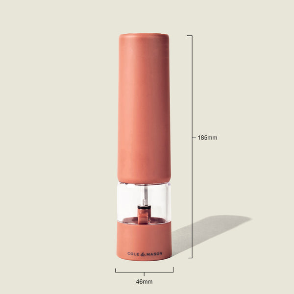 The Cole & Mason Brixton Electric Mill Terracotta GS is a tall, cylindrical pepper grinder in a terracotta color, measuring 185mm in height and 46mm in width. Shown upright on a light background, this rechargeable electric mill is equipped with a durable ceramic grinding system to ensure efficient and consistent seasoning.