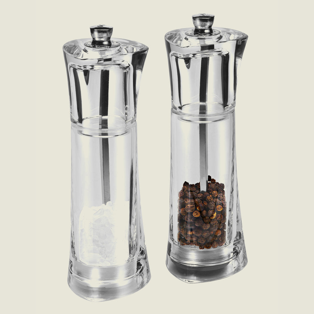 The Cole & Mason UK Prism Salt & Pepper Mill Set Acrylic 165mm features two clear mills—one with white salt crystals, the other with black peppercorns—each with adjustable grind and durable stainless steel mechanism, set side by side on a plain background.