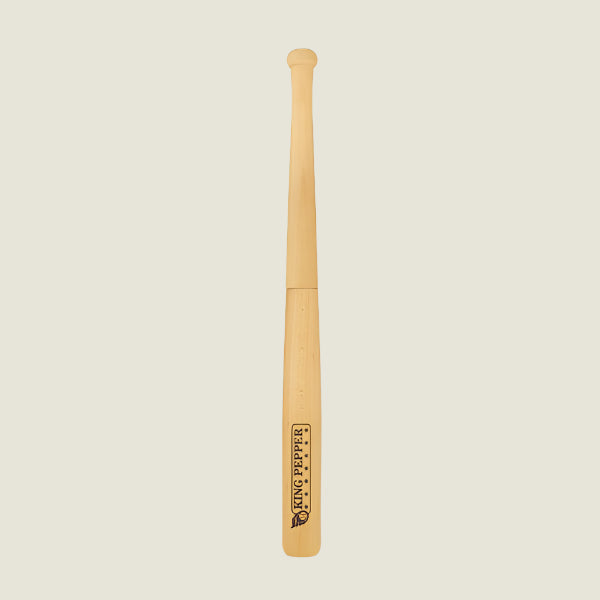 A 710mm King Pepper Baseball Bat Pepper Mill by Cole & Mason UK stands upright on an off-white background, its light natural finish features a Tiny Peppy logo near the bottom and a design inspired by the classic King Pepper mill.