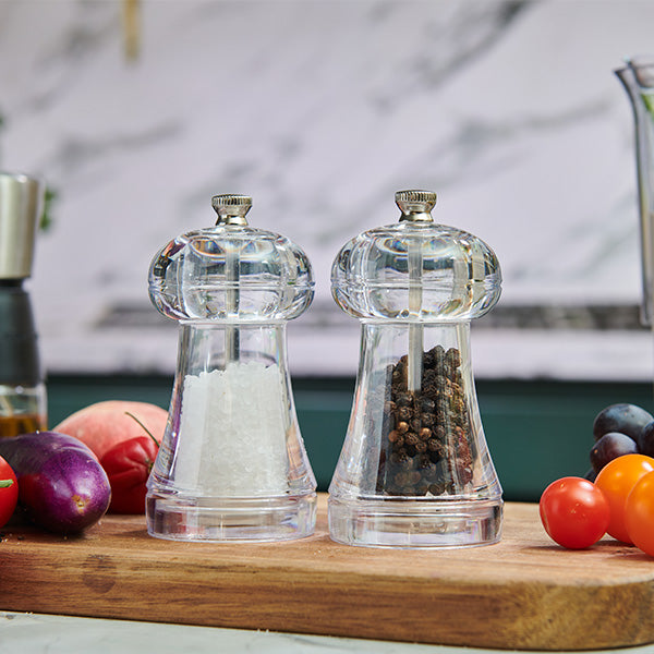 The Cole & Mason UK Everyday Salt & Pepper Mill Set Acrylic 110mm includes two clear mills—one with coarse white salt, one with whole black peppercorns. Both feature adjustable grinds and durable ceramic mechanisms for perfect seasoning.