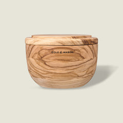 The Portobello Olive Wood Salt Cellar by Cole & Mason features natural grain patterns, a matching lid, and the brand logo on the front, adding timeless charm to your kitchen decor. Shown against a plain light background.