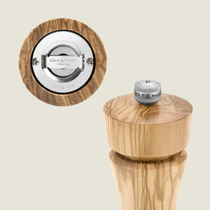 #pepper A close-up of the Cole & Mason Portobello Olive Wood Salt & Pepper Mills, featuring adjustable grind, metal mechanism, and a top knob with "P"—beautifully packaged in a premium gift box.