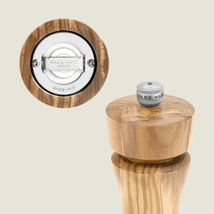 #salt&pepperset The Cole & Mason Portobello Olive Wood Salt & Pepper Mill features a precision mechanism with stainless steel parts and an adjustable silver knob labeled "S," engraved with "COLE & MASON ENGLAND SINCE 1919.