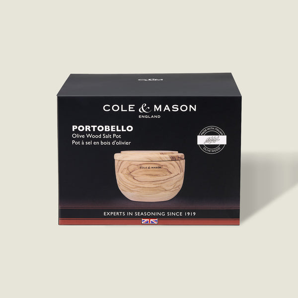 A Cole & Mason box displays the Portobello Olive Wood Salt Cellar—a small, round wooden container with a lid. The mostly black packaging features white text and a product image, making it perfect for stylish kitchen decor.