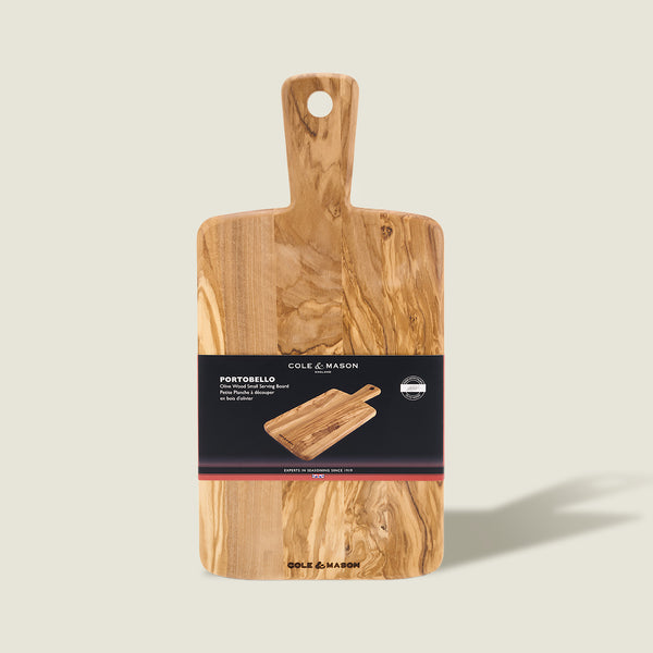 The Cole & Mason Portobello Olive Wood Serving Boards Set is shown against a light background, with packaging displaying an image of the boards and product details.