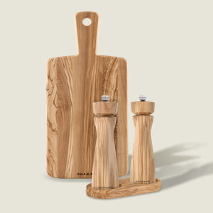 Cole & Mason’s Portobello Mills, Tray & Small Serving Board set features matching Italian olive wood salt and pepper mills on a tray, with a small serving board standing upright behind—all in natural light wood grain.