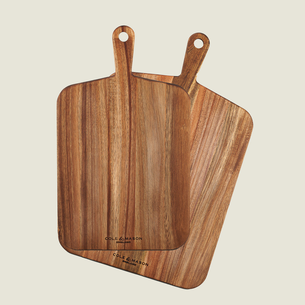Two Cole & Mason Barkway boards overlap on a light background. Both feature natural acacia wood grain, rounded edges, and handles—an essential 2-piece bundle for any kitchen.