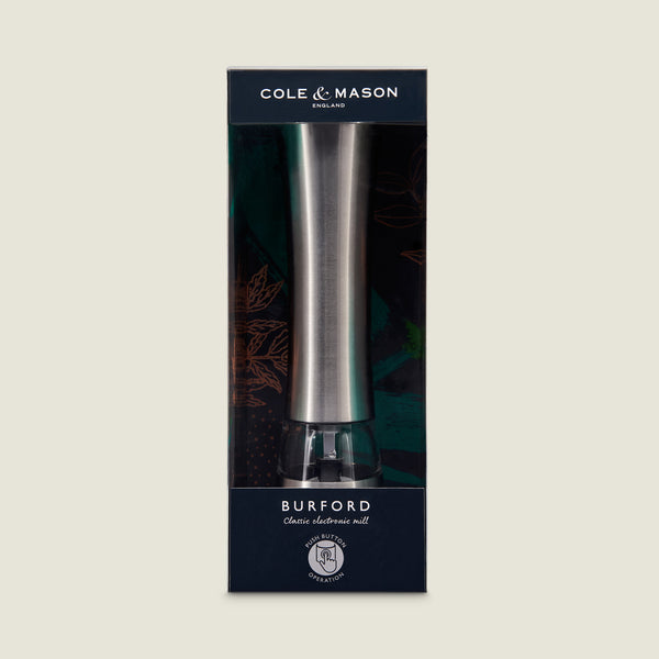 The Cole & Mason Burford Electronic Single Mill features a tall, sleek stainless steel design, electronic grinding with adjustable settings, and comes in original dark blue and green Burford Classic packaging.