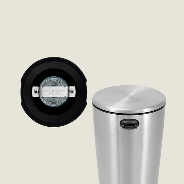 A stainless steel cylindrical Electric Derwent Salt & Pepper Mill with a USB-C port, shown upright. Next to it is a close-up of its base, revealing a transparent window and the Cole & Mason brand mark.