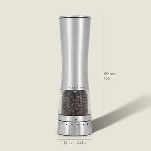 The Cole & Mason Electric Derwent Pepper Mill features a tall, silver design with a transparent lower section filled with peppercorns, measuring 192 mm (7.56 in) high and 60 mm (2.36 in) wide.