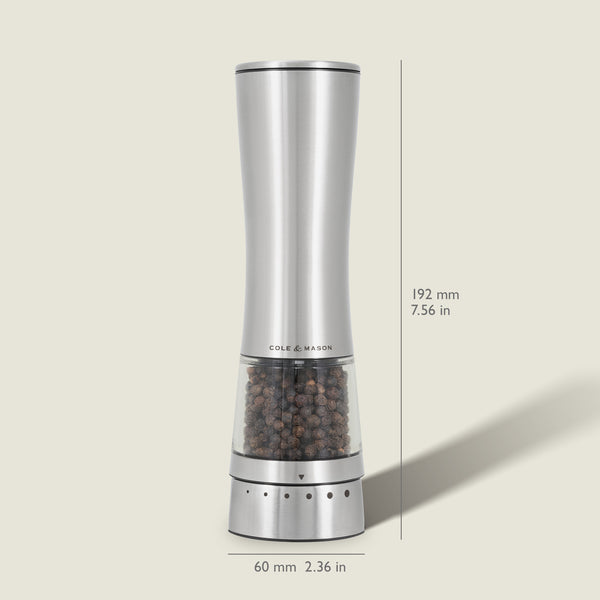 The Cole & Mason Electric Derwent Pepper Mill features a tall, silver design with a transparent lower section filled with peppercorns, measuring 192 mm (7.56 in) high and 60 mm (2.36 in) wide.