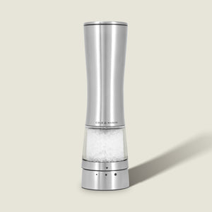 A Cole & Mason Electric Derwent Salt & Pepper Mill, crafted from stainless steel with a transparent base filled with coarse salt, stands upright on a light beige background.