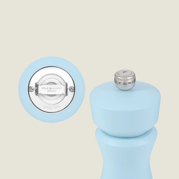 A close-up of the Cole & Mason Kenton Salt & Pepper Mill in Blue Salt, featuring a silver "P" knob, ceramic mechanism, and brand logo on the bottom.