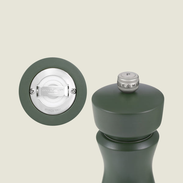 The Kenton Salt & Pepper Mill in Rosemary by Cole & Mason features a matte dark green finish, a silver P-knob on top, and an underside ceramic mechanism marked "Cole & Mason London.