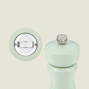 The Kenton Salt & Pepper Mill in Sage by Cole & Mason stands upright, showing a ceramic base mechanism and brand logo. The customizable mill features a top metal knob marked with a P.