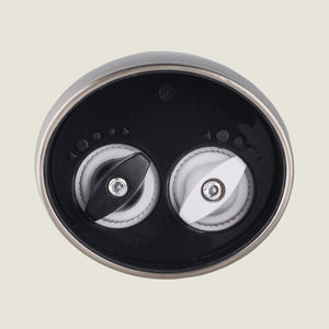 The Cole & Mason Kew Electronic 2-in-1 Duo Mill features two rotating burrs—one black, one white—for customizable grinding, with adjustable settings, shown close-up against a plain light background.