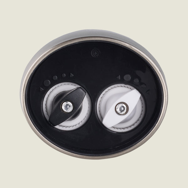 The Cole & Mason Kew Electronic 2-in-1 Duo Mill features two rotating burrs—one black, one white—for customizable grinding, with adjustable settings, shown close-up against a plain light background.