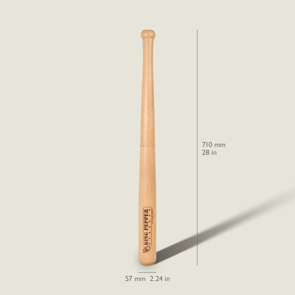 A Cole & Mason King Pepper Baseball Bat Pepper Mill 710mm stands upright on a light background, with measurements labeled: 710 mm (28 in) tall and 57 mm (2.24 in) wide. Inspired by the iconic design of the King Pepper mill, it features a logo near the base and highlights its durable carbon steel mechanism for long-lasting performance.