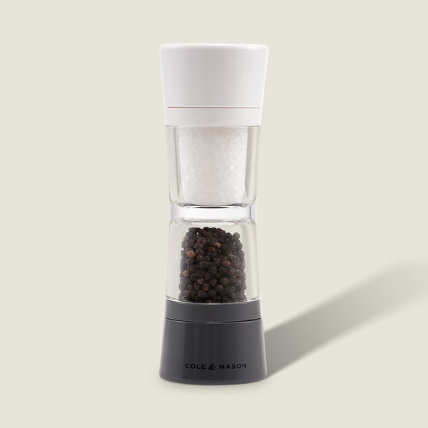 The Cole & Mason Lincoln 2-in-1 Duo Mill grinder has adjustable settings, a white top for salt, and a black base for peppercorns, shown against a light background.