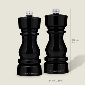 The Cole & Mason London Black Acrylic Salt & Pepper Mills (150mm) feature premium grinding technology and a glossy finish, standing 150 mm tall and 57 mm wide, shown side by side on a neutral background.