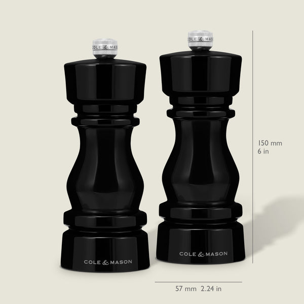 The Cole & Mason London Black Acrylic Salt & Pepper Mills (150mm) feature premium grinding technology and a glossy finish, standing 150 mm tall and 57 mm wide, shown side by side on a neutral background.