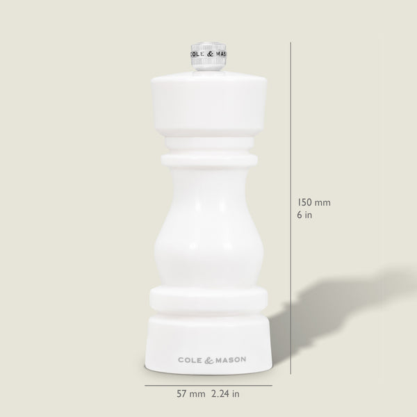 The Cole & Mason London White Acrylic Salt & Pepper Mill, measuring 150mm (6 in) tall and 57mm (2.24 in) wide, features an adjustable grinder—perfect for modern kitchens. Pictured upright on a light beige background.