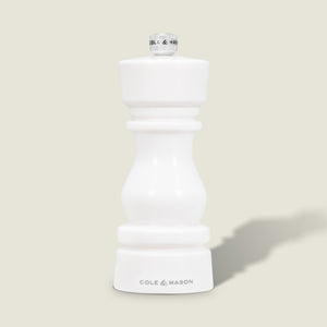 The Cole & Mason London White Acrylic Salt & Pepper Mill (150mm) features a modern, curved design, adjustable grind, and brand logo at the base—perfect for contemporary kitchens. It stands upright on a light gray background with a subtle shadow.