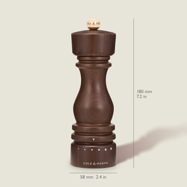 A dark wooden London Walnut Salt or Pepper Mill by Cole & Mason stands upright, measuring 180 mm (7.2 in) tall and 58 mm (2.4 in) wide, with size markings visible on a cream background, making it a classic seasoning mill for your kitchen.