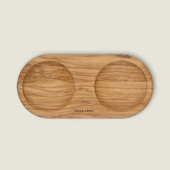 The Portobello Olive Wood Mill Tray by Cole & Mason is a rectangular tray with rounded edges, two circular indentations for mills, and "COLE & MASON" engraved in the center.