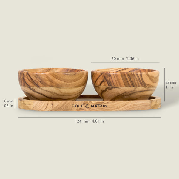 The Cole & Mason Portobello Olive Wood Serving Board & Pinch Pot Set features two small olive wood pinch pots (60mm wide, 28mm tall) on a matching tray (124mm long, 8mm high) engraved with the brand name on the front.