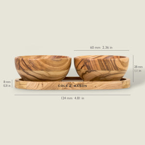 The Cole & Mason Portobello Olive Wood Pinch Pot Set includes two 60 mm x 28 mm pots for salt and pepper on a 124 mm x 8 mm oval tray—ideal for seasoning.
