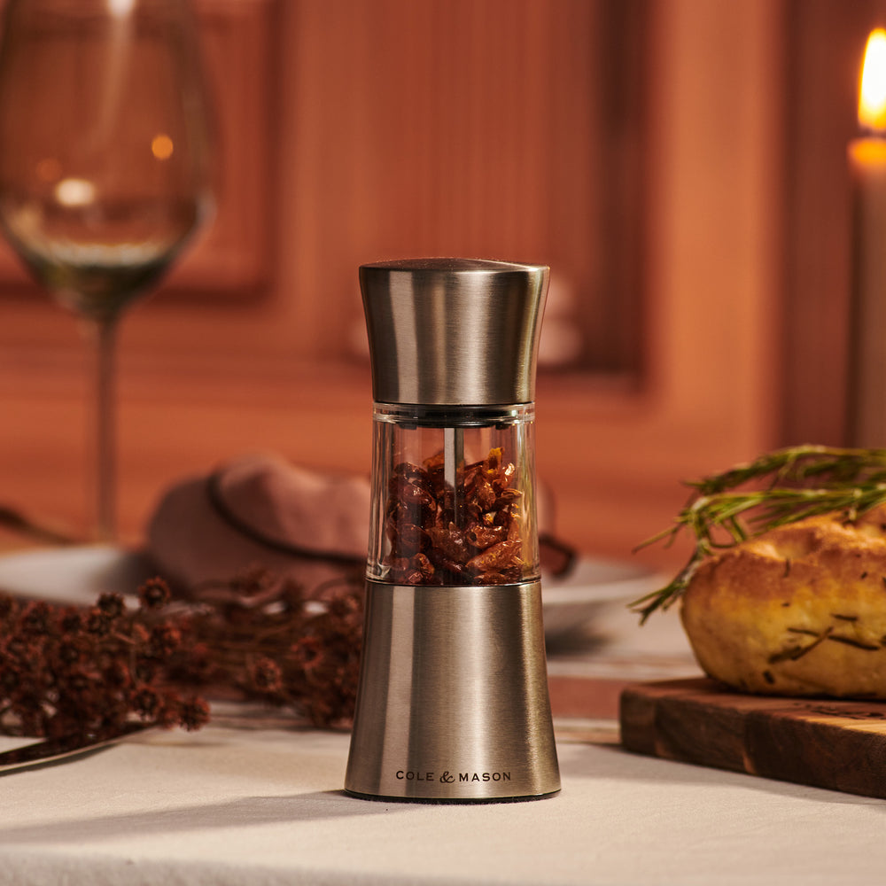 The Cole & Mason Stadhampton Chilli & Spice Mill features stainless steel and clear acrylic with an ergonomic design, COLE & MASON branding at the base, shown upright against a plain light background.