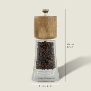 The Cole & Mason Woodbury Salt & Pepper Mill Set features clear mills with wooden tops, adjustable coarseness, and bold branding on the base. Each mill stands 134 mm tall and 54 mm wide, adding rustic charm to your table.
