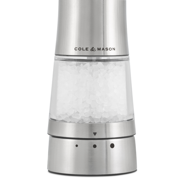 A stainless steel Electric Derwent Salt & Pepper Mill by Cole & Mason, prefilled with coarse salt and featuring adjustable grind settings at the base, delivers effortless and precise seasoning with a blend of style and convenience.
