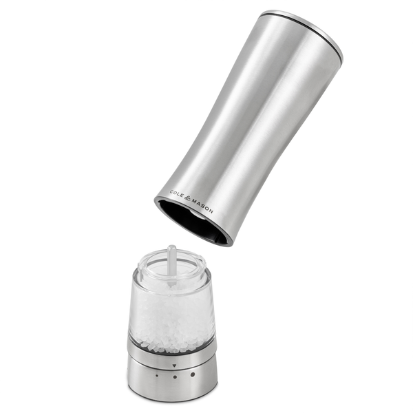 A Cole & Mason Electric Derwent Salt & Pepper Mill, crafted from stainless steel, is shown with its top removed to reveal the clear chamber filled with coarse salt crystals—an innovative and contemporary upgrade for your collection of electric mills.