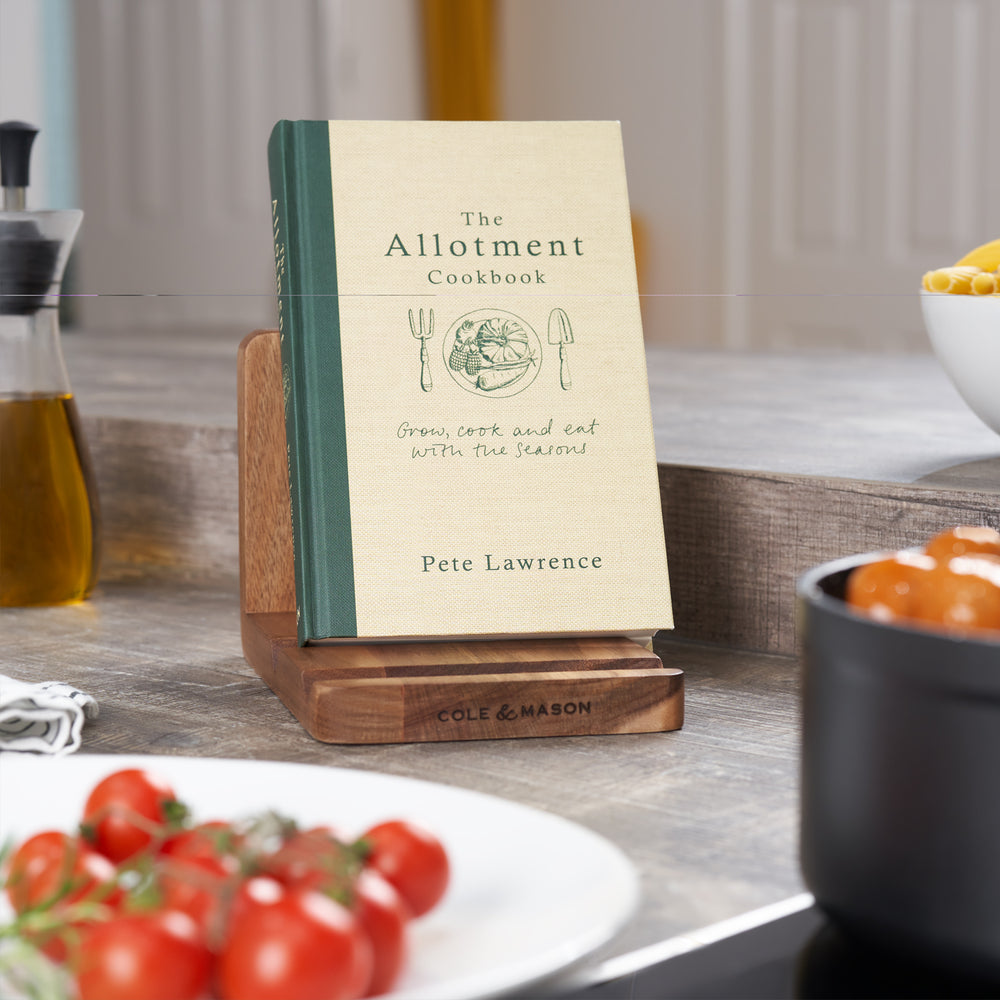 The Buckland Acacia Recipe Cook Book & Tablet Stand by Cole & Mason UK features three angled slots, ideal for holding devices, cookbooks, or recipe cards. Cole & Mason is branded on the front edge.
